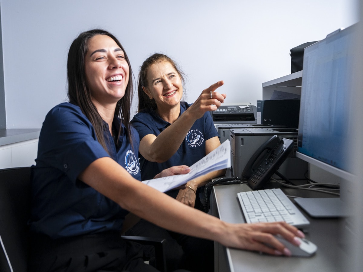 Two members of the Manly Foot Clinic team at the reception desk